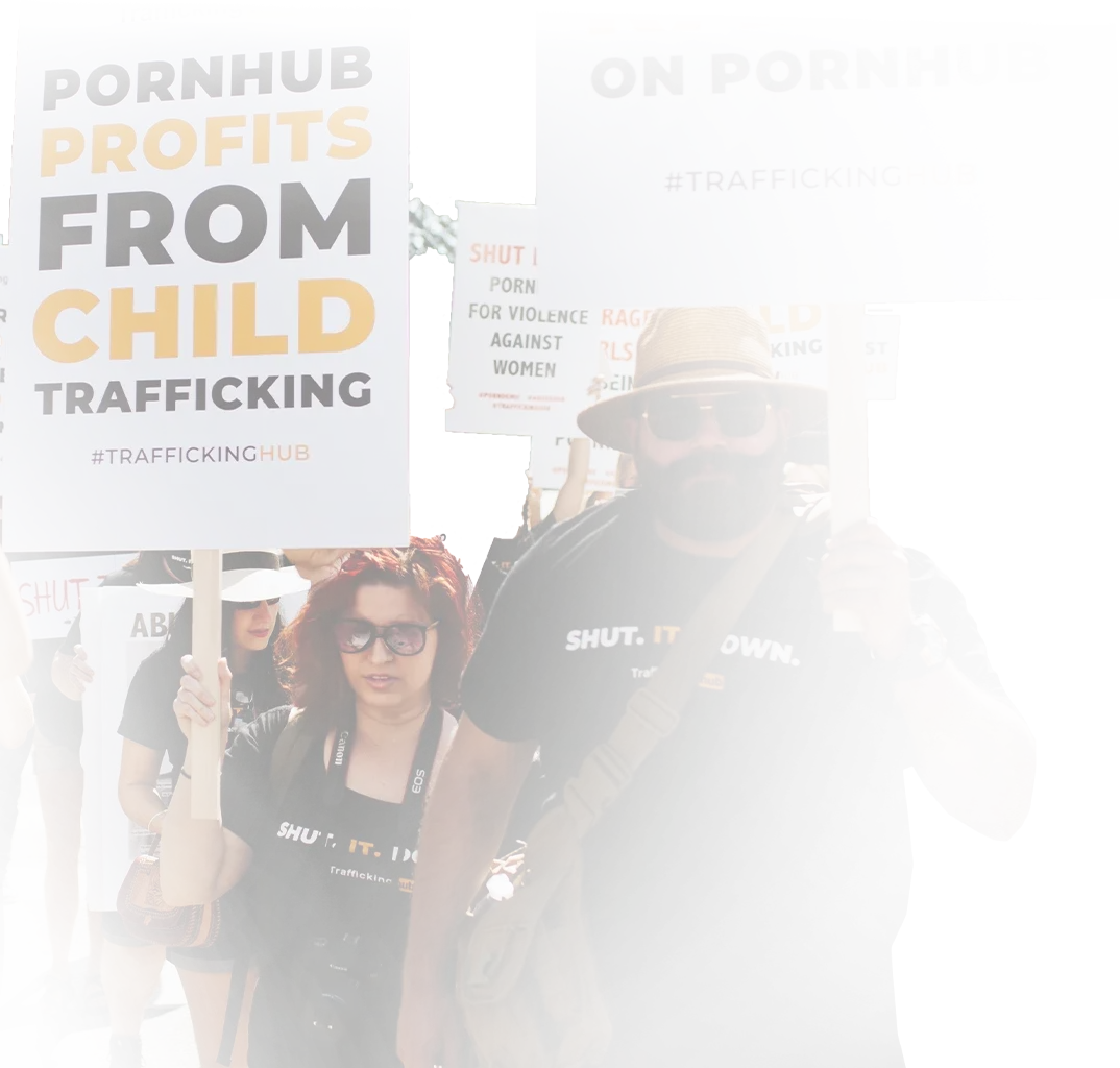 A group of people hold up Traffickinghub signs at a protest